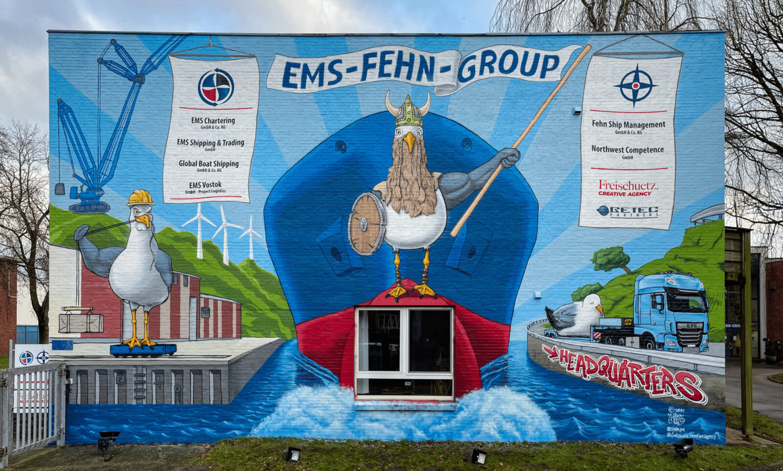 Graffiti am Bürogebäude der EMS-Fehn-Group mit Möwen-Maskottchen & Firmen-Logos